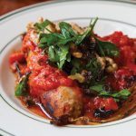 A Recipe for September: Dan Holzman’s Braised Sausage and Endive in Tomato Sauce