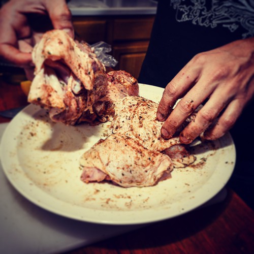 Juan, packing spice into the fleshy hunks, being mindful of the birds various nooks and crannies.