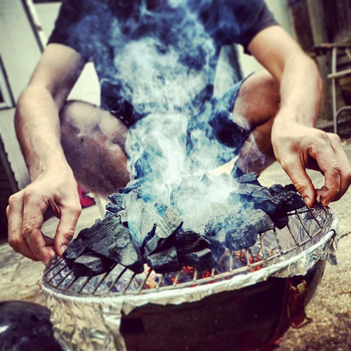 Juan, getting the charcoals crackling.
