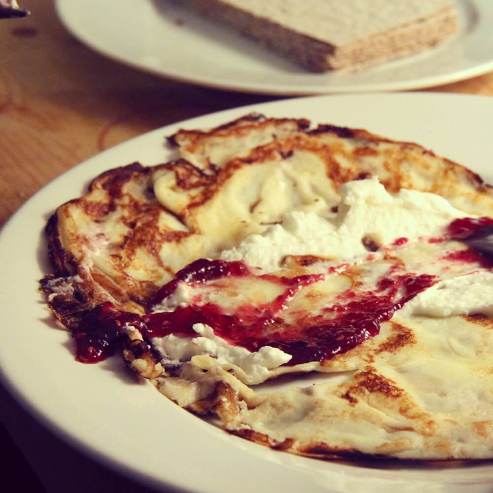 The finished Pannkakor, dolled up with raspberry jelly and whipped cream.