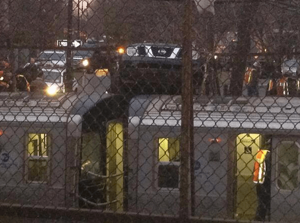 car lands on top of Q train