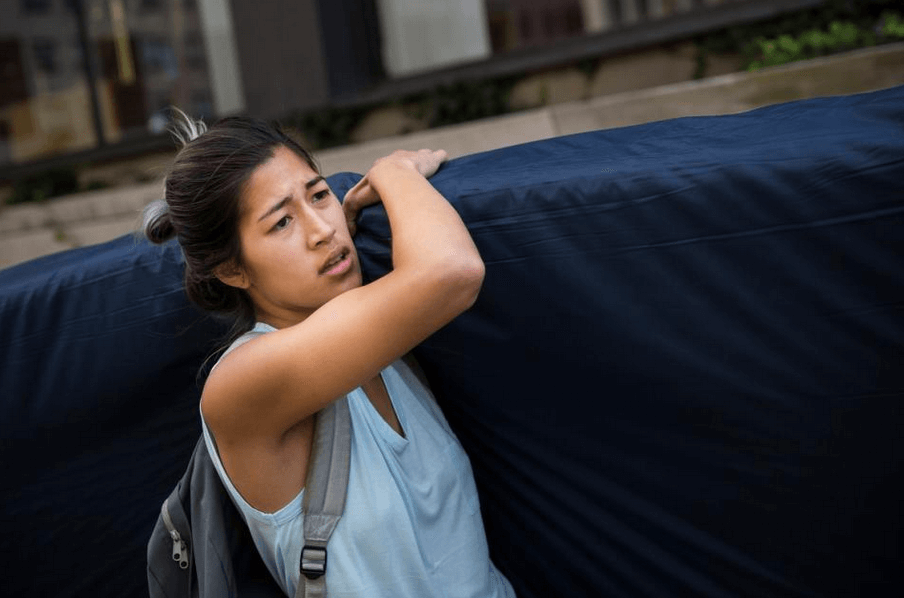 Emma Sulkowicz, carrying her mattress in protest. Photo via Andrew Burton/Getty