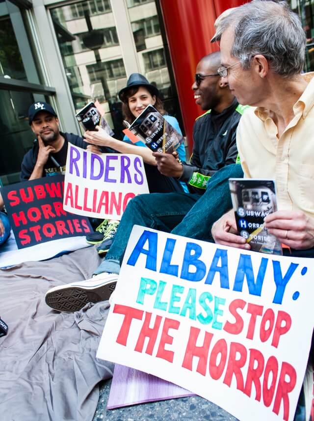 Protesters reading "Subway Horror Stories" outside Governor Cuomo's office (via Riders Alliance)