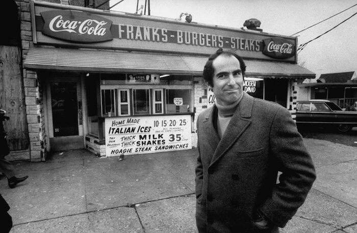 Author, Philip Roth, revisiting areas where he grew up in Newark, standing at hamburger stand.  (Photo by Bob Peterson//Time Life Pictures/Getty Images)
