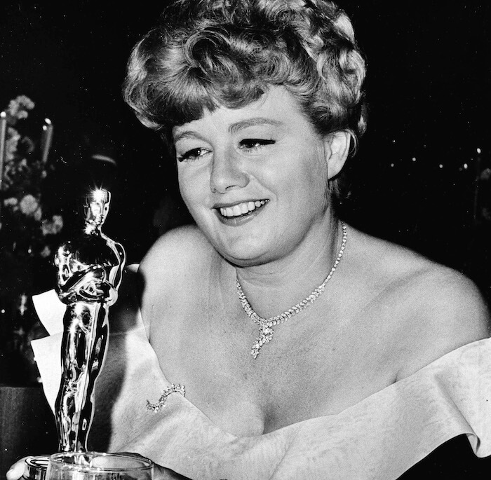 U.S. actress Shelley Winters, whose role in "A Patch of Blue" won her the 'Best Supporting Actress' Oscar at last night's Academy Awards, admires the Golden Statuette at an Academy party, Santa Monica, CA, April. 19, 1966. (AP Photo)