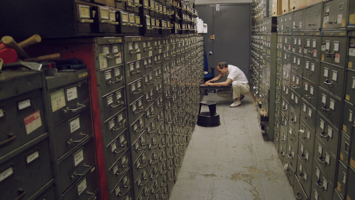 Last remaining archivist Jeff Roth searches The New York Times morgue. Courtesy of Kino Lorber.