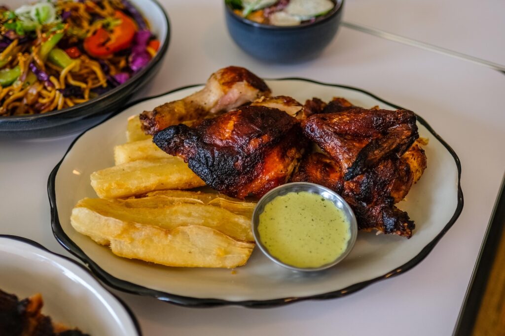 Half rotisserie chicken combo plate with yuca fries and a salad at Johnny's, $25