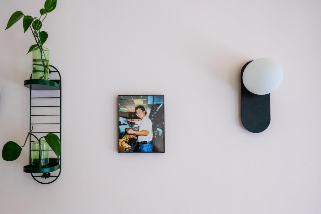 Family photos hang on the wall, including this shot of Johnny Tang, for whom the place is named 