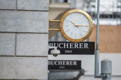 Rolex watch clock mounted above the Bucherer store display on Rue du Rhône on August 2, 2025 in Geneva, Switzerland.