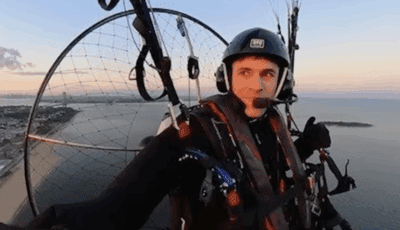 Jonathan "Fan Man" Warren flying over Brooklyn in his personal paraglider