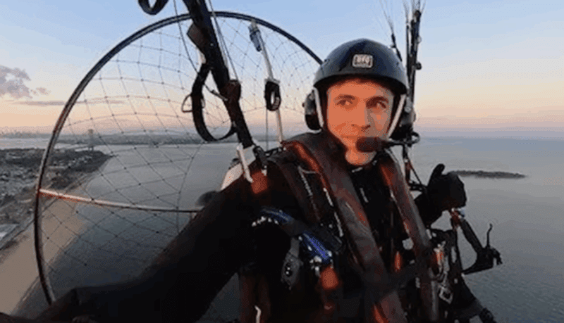 Jonathan "Fan Man" Warren flying over Brooklyn in his personal paraglider