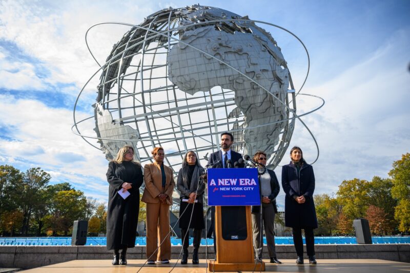 Mayor-elect of New York City Zohran Mamdani (C) stands alongside members of his transition team, (L-R) Transition Executive Director, Elana Leopold, Transition Co-chairs, Melanie Hartzog, Maria Torres-Springer, Grace Bonilla, Lina Khan, as he speaks during a press conference at the Unisphere in Flushing Meadows Corona Park on November 05, 2025 in the Queens borough of New York City. Mamdani won a historic victory to become the city's 111th mayor defeating independent mayoral candidate Andrew Cuomo and Republican mayoral candidate Curtis Sliwa.