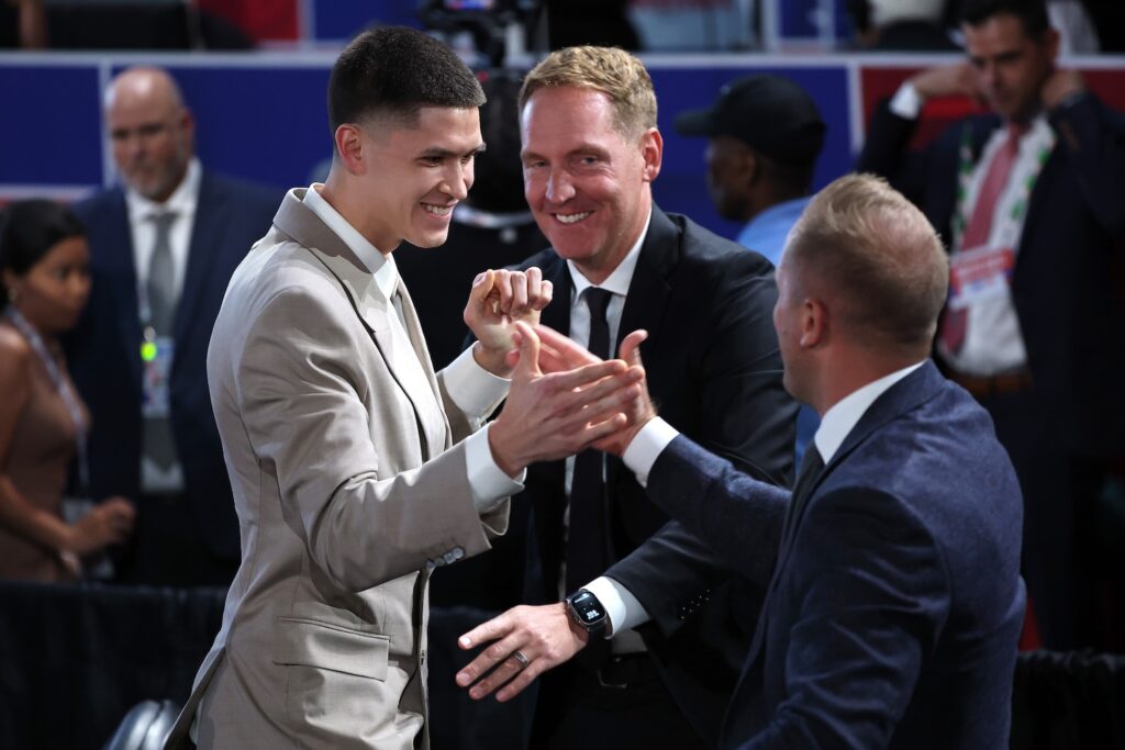 Egor Demin celebrates with members sitting at his table after being drafted eighth overall by the Brooklyn Nets during the first round of the 2025 NBA Draft at Barclays Center on June 25, 2025. 