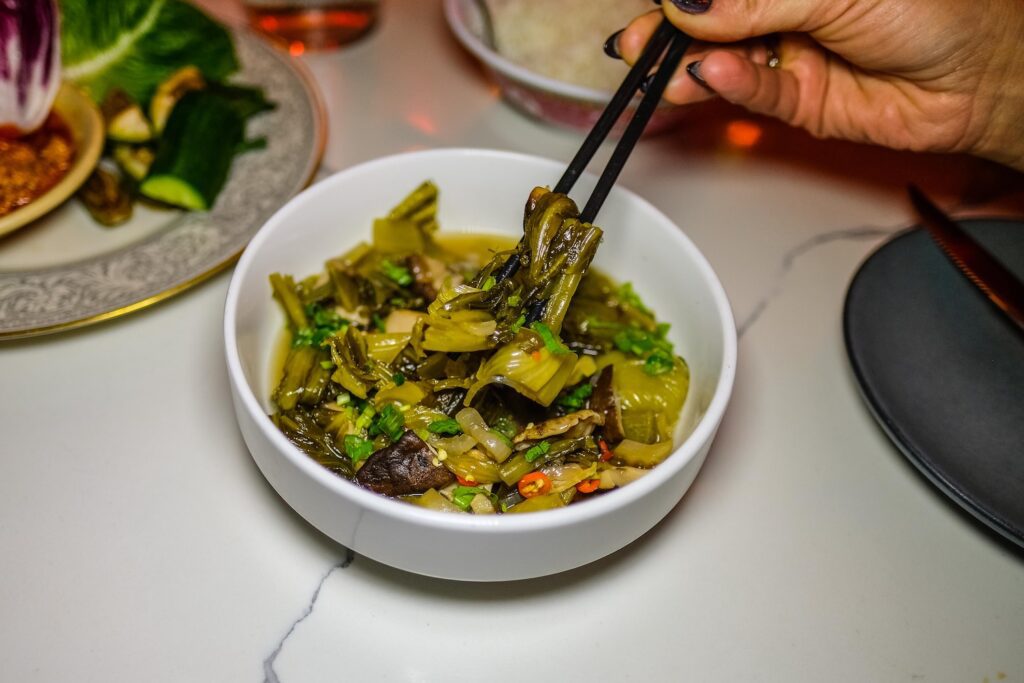 Braised mustard greens with shiitake and rice, $20, from the Hōp residency at Runner Up in Park Slope, Brooklyn