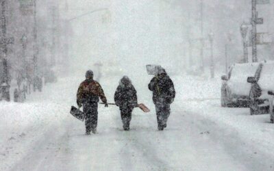 A group looking for work shoveling snow walks down the street February 12, 2006 in the Brooklyn borough of New York City. A nor?easter that moved up the coast has dropped a 22 inches of snow in Central Park and may leave accumulations of over two feet in the city.