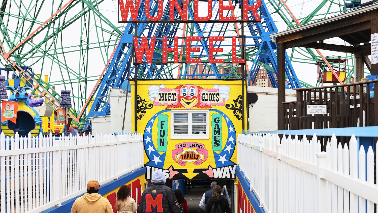 People walk towards the Wonder Wheel on the first day of the Coney Island parks reopening in the Coney Island neighborhood of Brooklyn borough on April 09, 2021 in New York City. Coney Island's Deno's Wonder Wheel Amusement Park and Luna Park opened today for the first time in 18 months after being closed due to the coronavirus (COVID-19) pandemic. Various government officials attended a ribbon-cutting ceremony to celebrate the reopening.