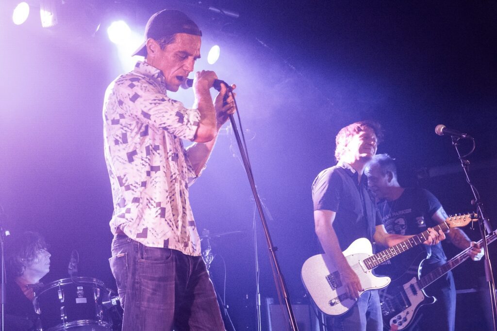Michael Shannon and Jason Narducy performing in their R.E.M. cover band.