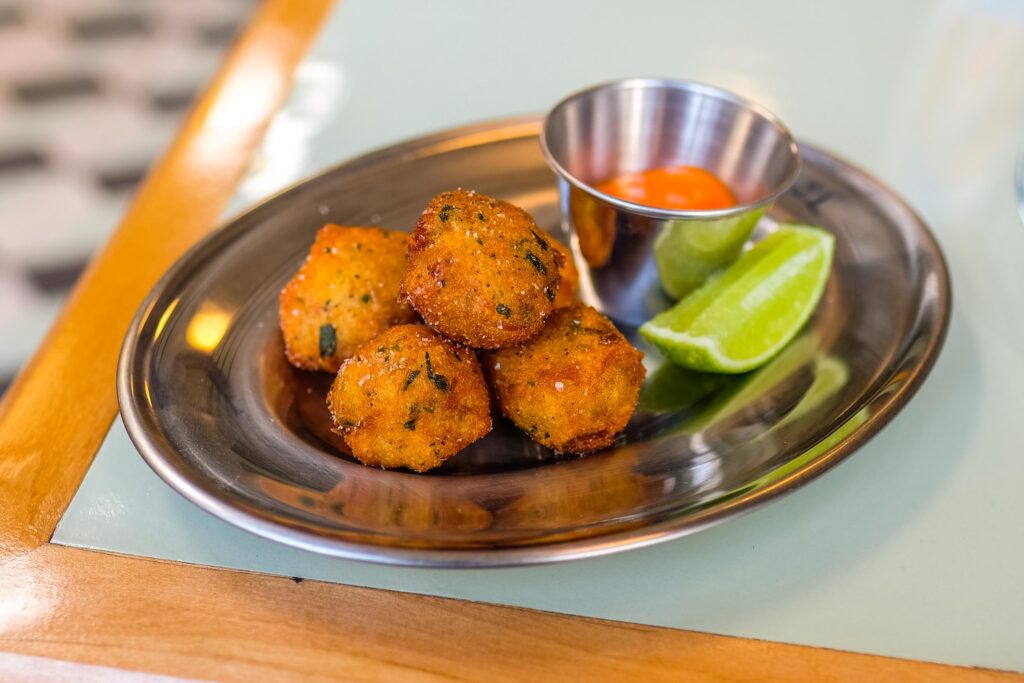 Bolinho de bacalhau (cod fritters) with fresno chili sauce, $14, at Bodega Nights in Bushwick