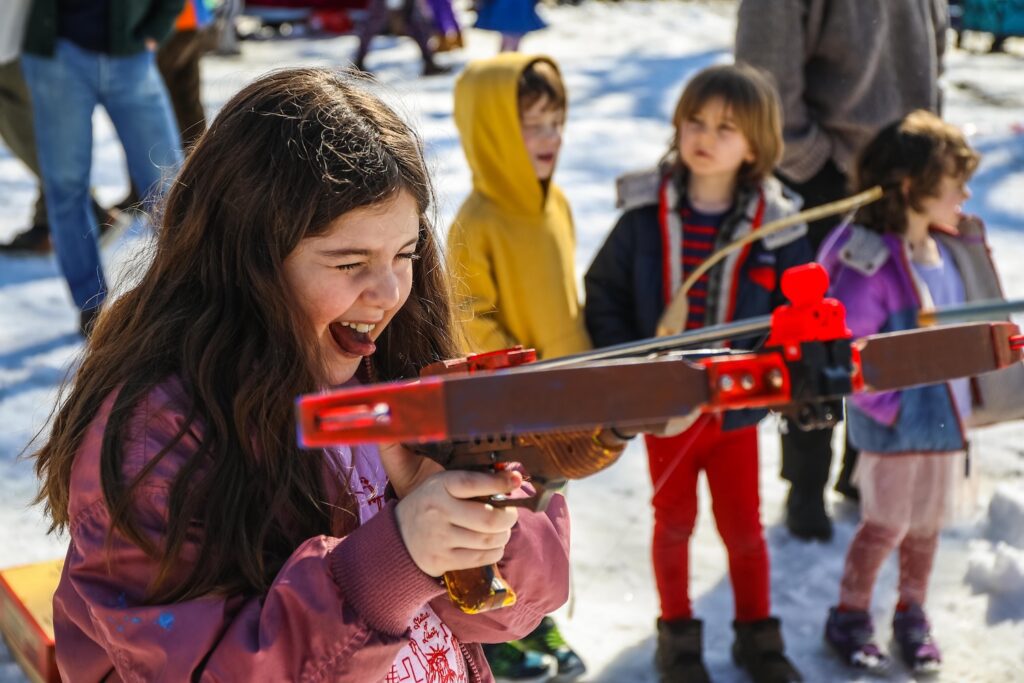 A young "Ramen Hood" takes from the King of Noodleham at the eighth annual Competitive Winter Picnicking Games in Bed-Stuy, Brooklyn