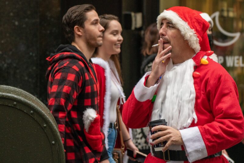 People dressed in Santa Claus costumes participate in SantaCon on December 11, 2021 in New York City. SantaCon, an annual Christmas themed pub crawl raising money for charity, returned this year after it was cancelled in 2020 due to the coronavirus pandemic.
