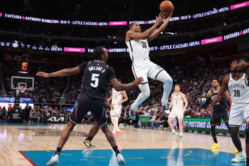 Ochai Agbaji #30 of the Brooklyn Nets drives past Ronald Holland II #5 of the Detroit Pistons to the basket in the first half at Little Caesars Arena on March 07, 2026 in Detroit, Michigan.